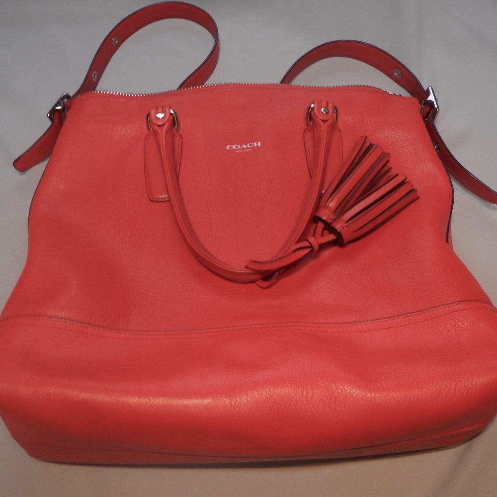 Dark coral Coach shoulder bag with tassels